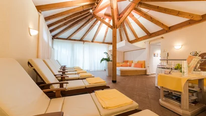 Relax room with lounge chairs, wooden beam ceiling, and daybed with cushions