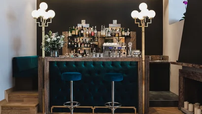 Elegant bar with blue stools and glowing floor lamps