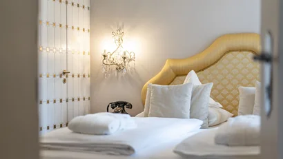 Elegant hotel room with cozy beds and vintage telephone